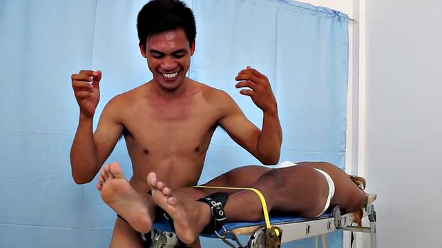 We strapped Hunter down on our tickling rack and released our sadistic ticklers Argie and Vahn on him. First was Argie.