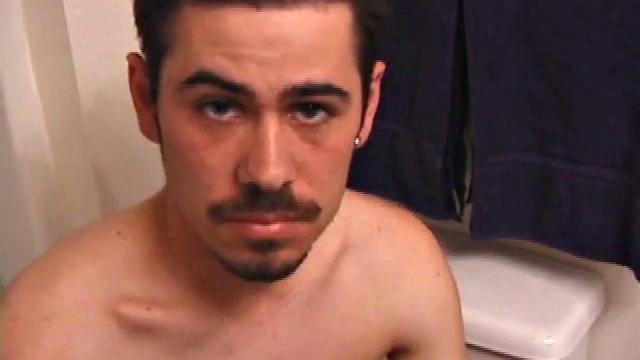 Marcus slips away to the bathroom with his laptop for private time.