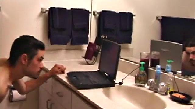 Marcus slips away to the bathroom with his laptop for private time.