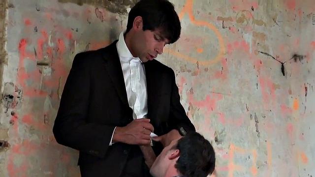 Tattooed guy doggystyled by suited man after throating