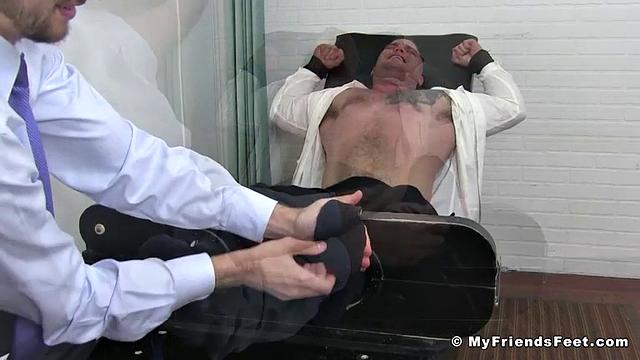 Daxx laughs and squirms while getting tickled by another man