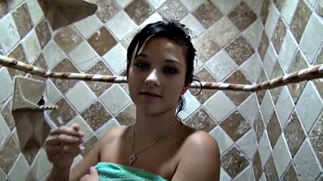 Showering solo teen masturbates under the water