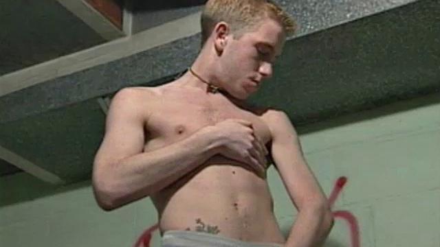 We look on as Corey Stevens sprays graffiti on a basement wall then strips naked to jack off