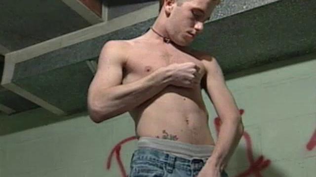 We look on as Corey Stevens sprays graffiti on a basement wall then strips naked to jack off