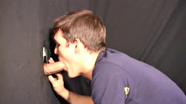 Sucking on a huge dick through a glory hole, 20 year old Nick shows his oral skills. The guy receiving the blow job loves it and in no time the stud strokes his cum load onto Nick's face.