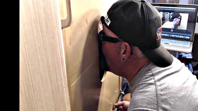 Gloryhole inked DILF sucks BFs cock through hole at home