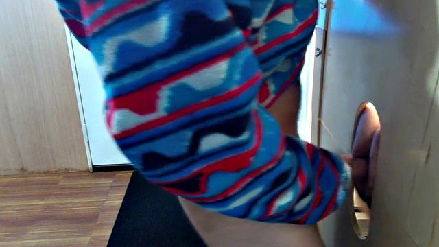 Gloryhole inked DILF sucks BFs cock through hole at home