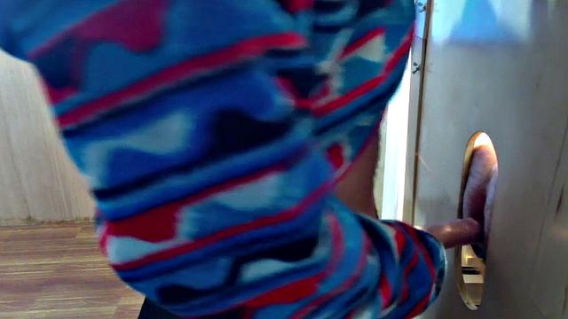 Gloryhole inked DILF sucks BFs cock through hole at home