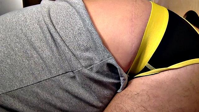 Gloryhole inked DILF sucks BFs cock through hole at home