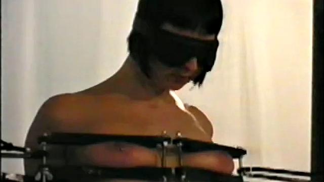 short haired brunette with mouth strapped