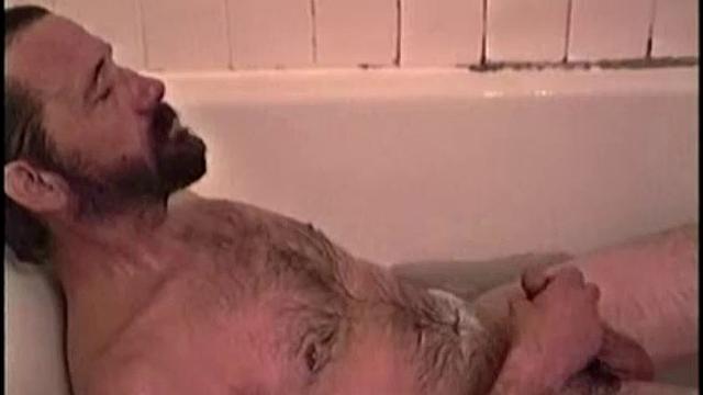 After staying the night and fucking me, I asked my friend Henry if I could film him in the bath tub shooting another load. He said sure, so here it is.
