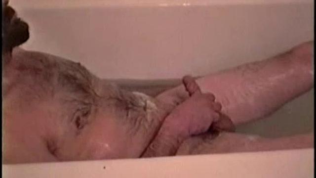 After staying the night and fucking me, I asked my friend Henry if I could film him in the bath tub shooting another load. He said sure, so here it is.