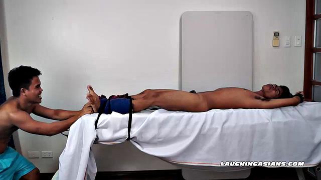 This cute tight-bodied ticklish Asian is Kenny Cruz. Jacob takes joy in strapping him down for some tickle fetish action.