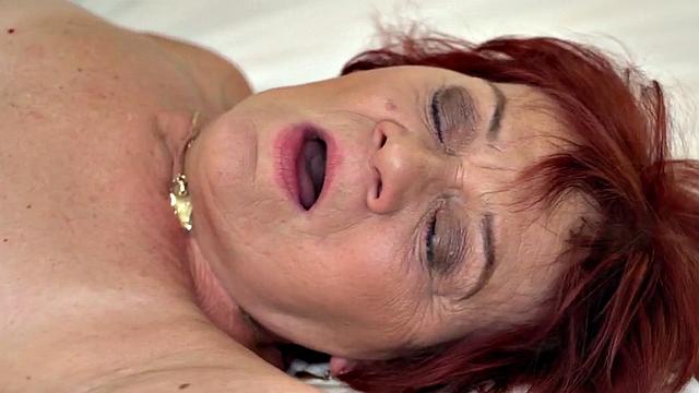 Redhead granny gets fucked in hairypussy by younger lover