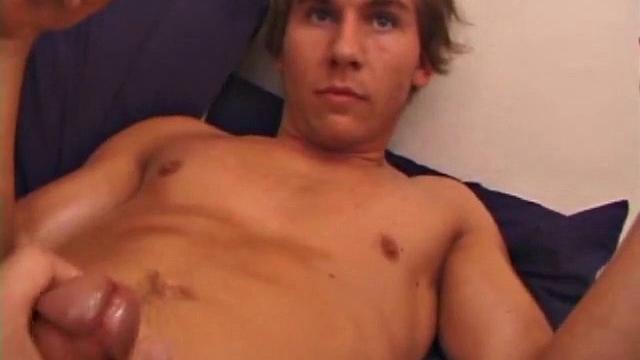 Sprawled out on the bed, Brock Labelli pulls out his cock and starts stroking. After the cameraman douses him with baby oil he continues to play with Brock's dick.