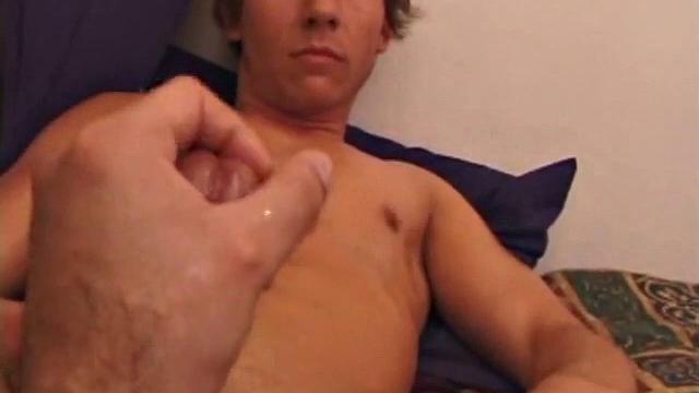 Sprawled out on the bed, Brock Labelli pulls out his cock and starts stroking. After the cameraman douses him with baby oil he continues to play with Brock's dick.