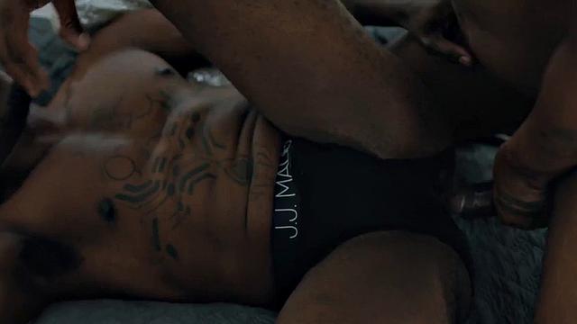 Muscular Jock pounding tattooed black stud on bed