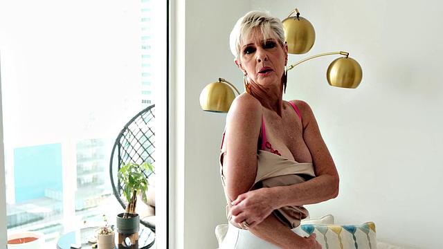 Meet Foxxxy, a 60-year-old MILF and GILF with big tits and a pierced clit