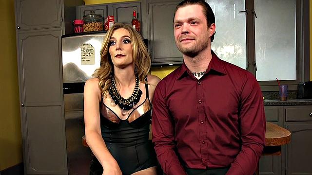 Leather domme humiliates subject in kitchen session