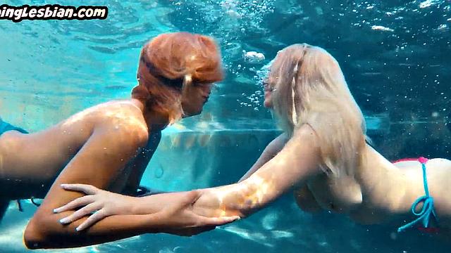 Busty lez babes playing with tits and scissoring outdoors by the pool