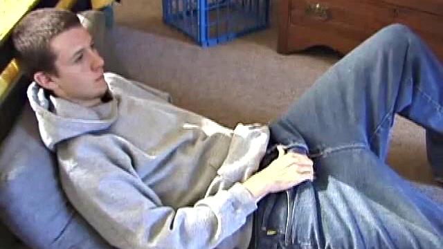 After using the remote to cue up a porn video, young Derek massages his crotch and wakes up his monster. Once the clothes are off, he starts to stroke and it doesn't take long for Derek to cum all over his hairy tummy.