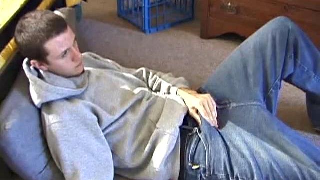 After using the remote to cue up a porn video, young Derek massages his crotch and wakes up his monster. Once the clothes are off, he starts to stroke and it doesn't take long for Derek to cum all over his hairy tummy.