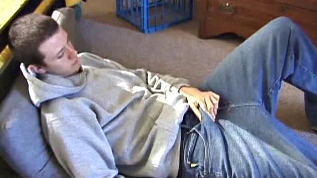 After using the remote to cue up a porn video, young Derek massages his crotch and wakes up his monster. Once the clothes are off, he starts to stroke and it doesn't take long for Derek to cum all over his hairy tummy.