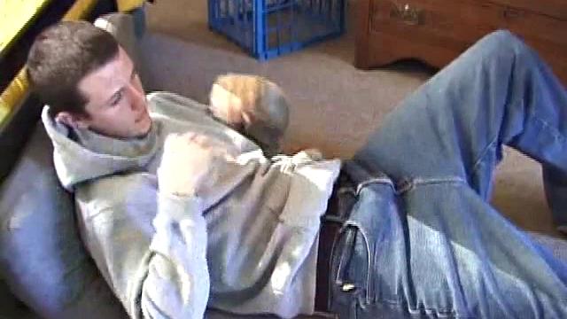 After using the remote to cue up a porn video, young Derek massages his crotch and wakes up his monster. Once the clothes are off, he starts to stroke and it doesn't take long for Derek to cum all over his hairy tummy.