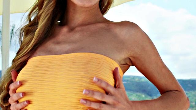 Watch Nancy, the naughty chick, tease her trimmed pussy in public with a thong