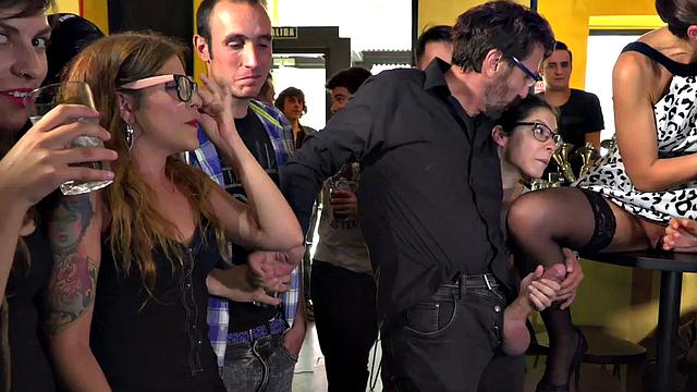 Public BDSM sub sucking dick and pussy licking in crowd