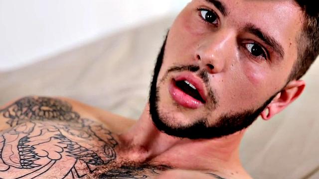Tattooed stud stroking hairy shaft during solo scene