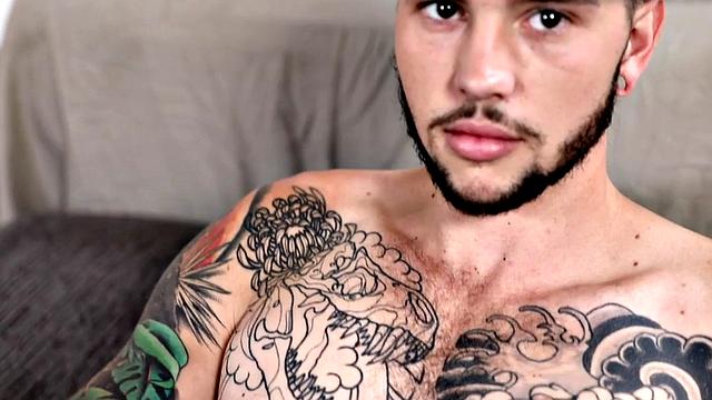 Tattooed stud stroking hairy shaft during solo scene