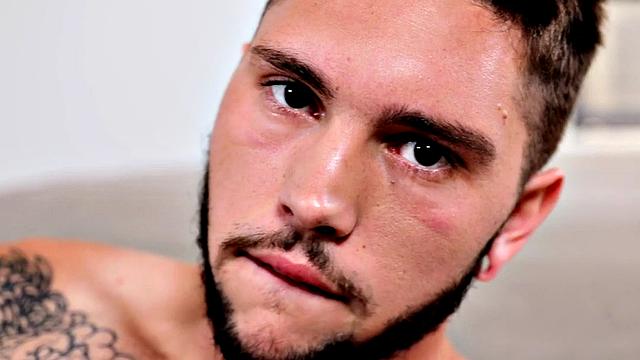 Tattooed stud stroking hairy shaft during solo scene