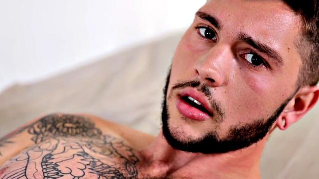 Tattooed stud stroking hairy shaft during solo scene