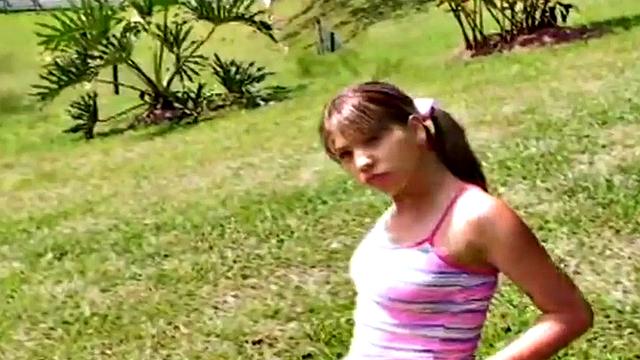 Petite teen strips off outdoors on grass