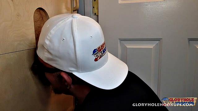 Latino guy slides his cock through the gloryhole and explodes with a messy cumshot on the other side