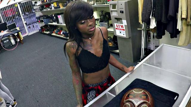 A tattooed ebony babe get her pussy pounded in a pawnshop while wearing a bra and a top