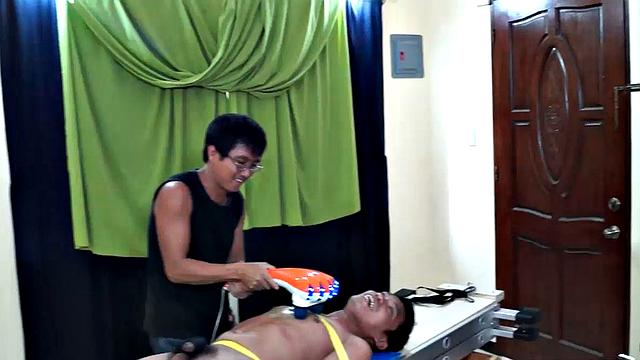 This Asian boy Lorenzo has some very ticklish feet. We strapped him down on the tickling rack and worked those smooth male soles. Ricky made sure to tickle the armpits while Daddy Mike feathered his soles.