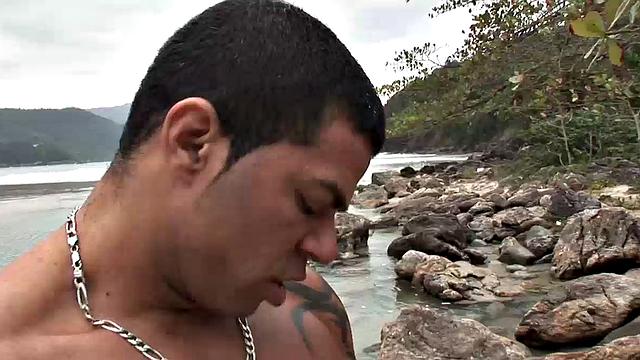 Muscle and big cock meet young Latin stud as Christian, Torquato and Junior Pavanello find a sandy patch on a rock-covered beach to get naked and fuck.