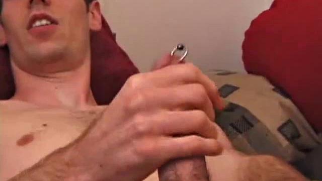 There's some good porn on the TV, so James Shafer decides to beat off. He pulls out his pierced cock and strokes it with determination, until he blows his load all over his chest.