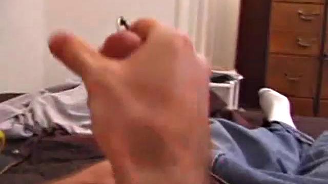 There's some good porn on the TV, so James Shafer decides to beat off. He pulls out his pierced cock and strokes it with determination, until he blows his load all over his chest.