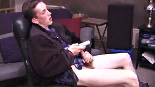 When Derek pulls down the pants his hard cock pops out and he begins stroking it. He obviously enjoys the porn video playing, because Derek soon pumps his warm cum onto his belly.