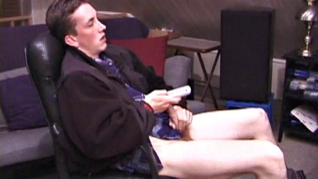 When Derek pulls down the pants his hard cock pops out and he begins stroking it. He obviously enjoys the porn video playing, because Derek soon pumps his warm cum onto his belly.