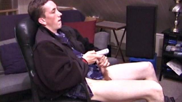 When Derek pulls down the pants his hard cock pops out and he begins stroking it. He obviously enjoys the porn video playing, because Derek soon pumps his warm cum onto his belly.