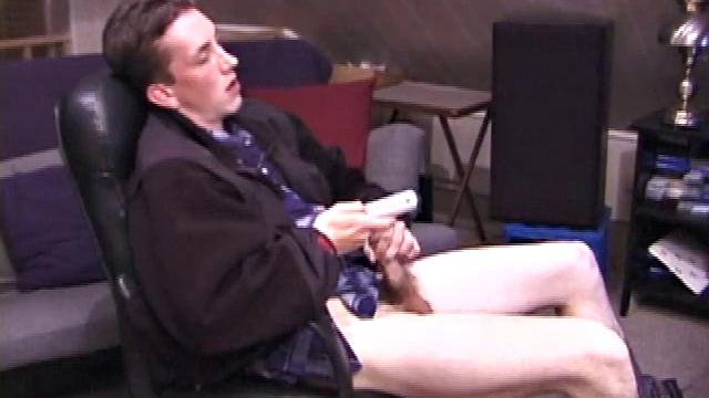 When Derek pulls down the pants his hard cock pops out and he begins stroking it. He obviously enjoys the porn video playing, because Derek soon pumps his warm cum onto his belly.