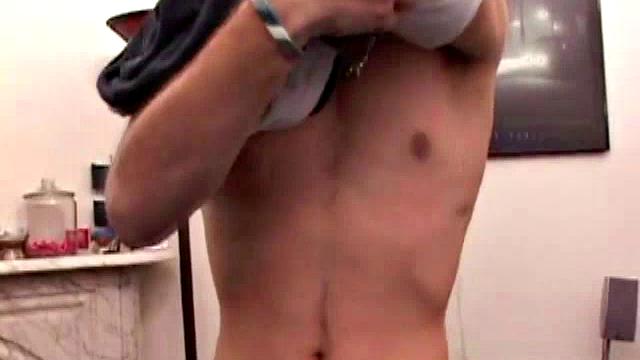 Adrian Knutts strips naked and works the remote control as he strokes his cock to the porn video.