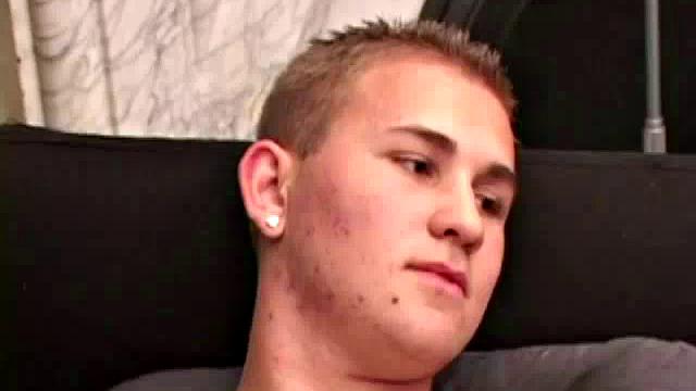 Adrian Knutts strips naked and works the remote control as he strokes his cock to the porn video.