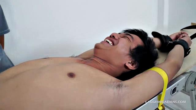 This adorable gay Asian boy is Ronny. He's 19 years old and insanely ticklish. This will be Ronny's introduction to the male tickling world as Ricky has him strapped down for some kinky fun.