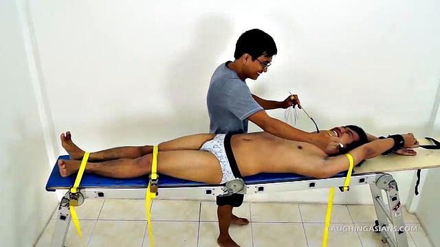 This adorable gay Asian boy is Ronny. He's 19 years old and insanely ticklish. This will be Ronny's introduction to the male tickling world as Ricky has him strapped down for some kinky fun.