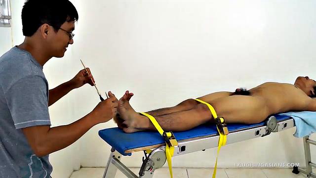 This adorable gay Asian boy is Ronny. He's 19 years old and insanely ticklish. This will be Ronny's introduction to the male tickling world as Ricky has him strapped down for some kinky fun.